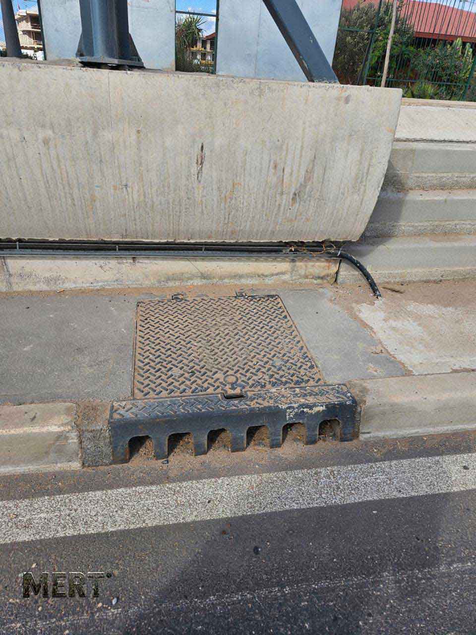 High-capacity kerb stormwater inlet and access cover installed beside a Casablanca road underpass