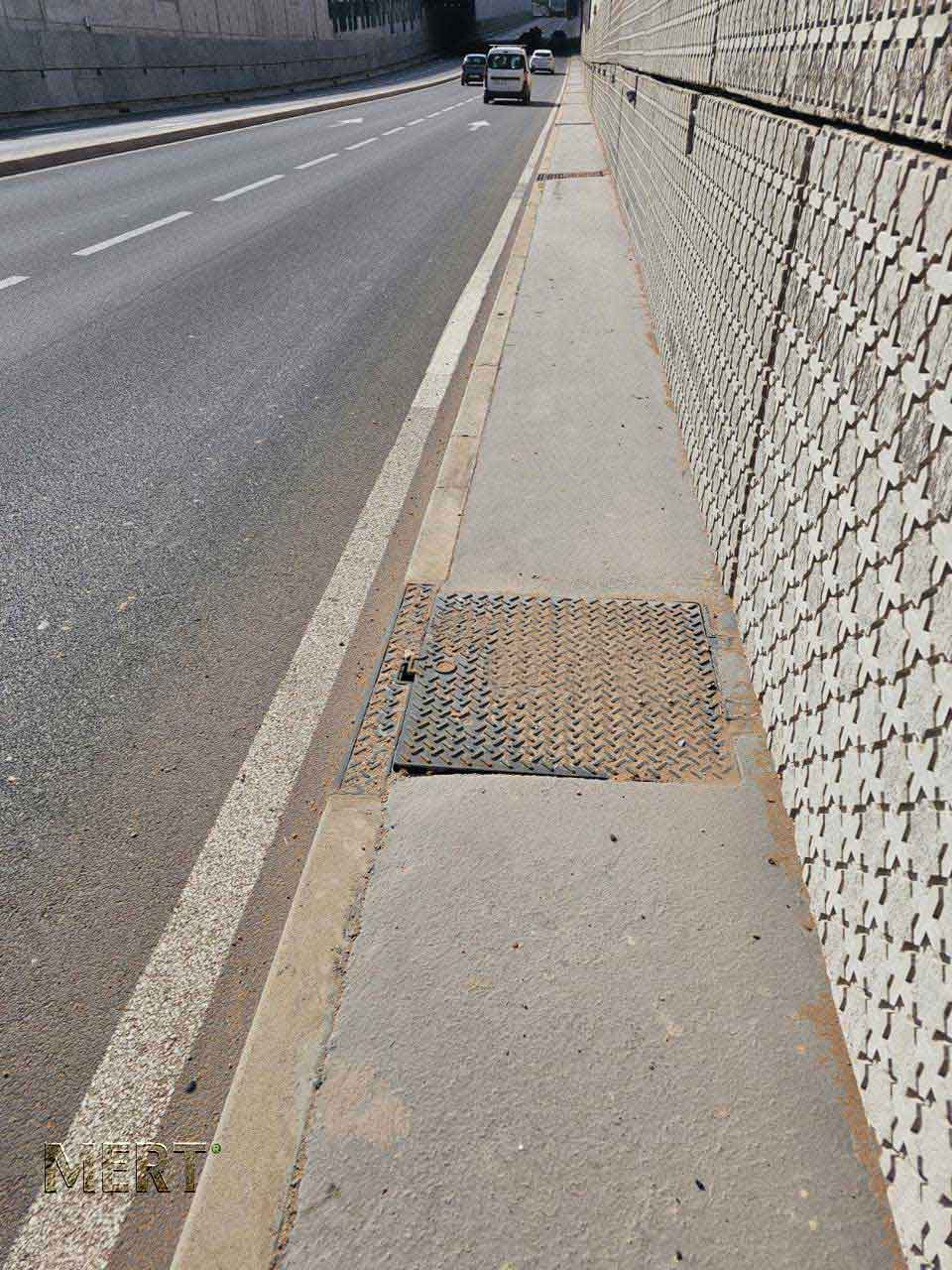 Access cover positioned in the maintenance walkway beside a Casablanca underpass